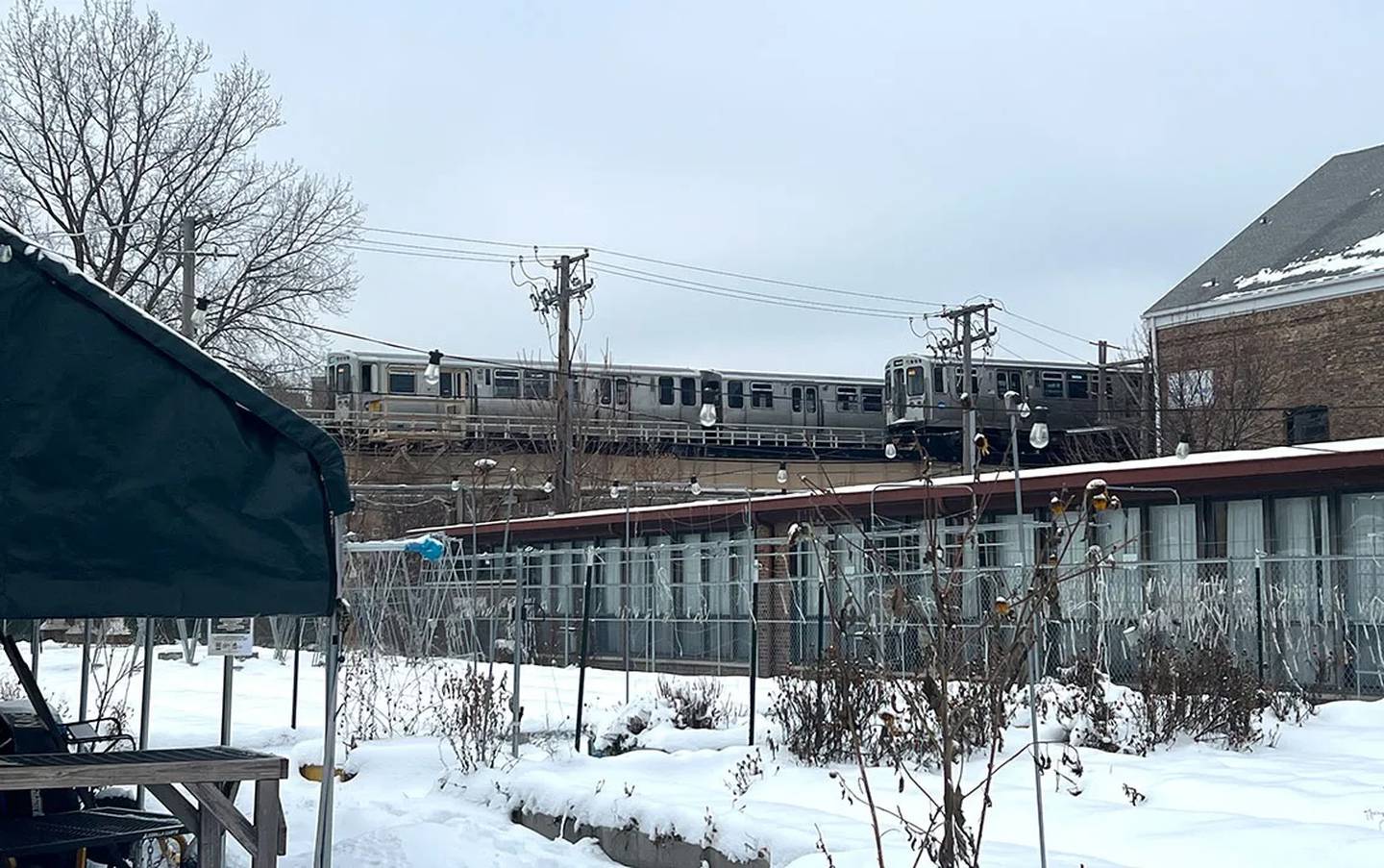 Two CTA Green line trains pass by the half-acre Just Roots community farm in Bronzeville on a snowy day in December. Just Roots purchased a refrigerated van and refrigeration infrastructure for its other farm in Sauk Village with support from Illinois’ Local Food Infrastructure Grant program.