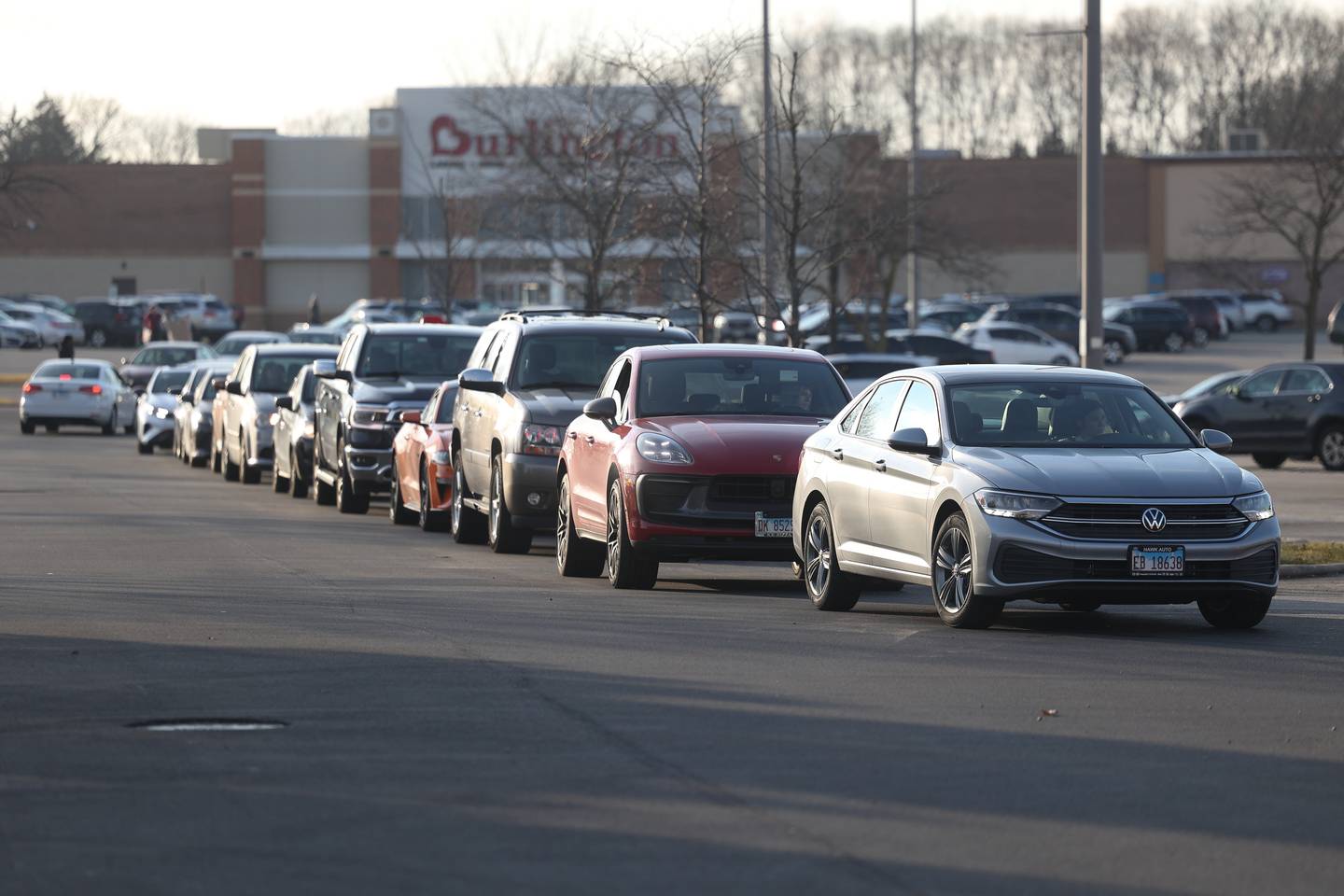 Hundreds of vehicles wrap around the shopping complex parking lot to order from CosMc’s, McDonald’s first small format beverage driven concept drive-thru, on Friday, Dec. 8, 2023 in Bolingbrook.