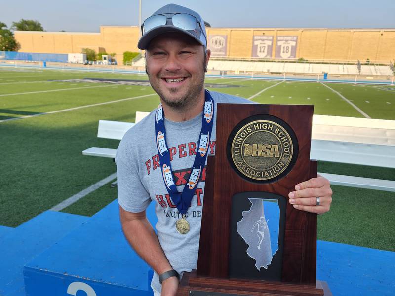 Huntley girls track and field coach Jason Monson and the Red Raiders' Class 3A state championship trophy.