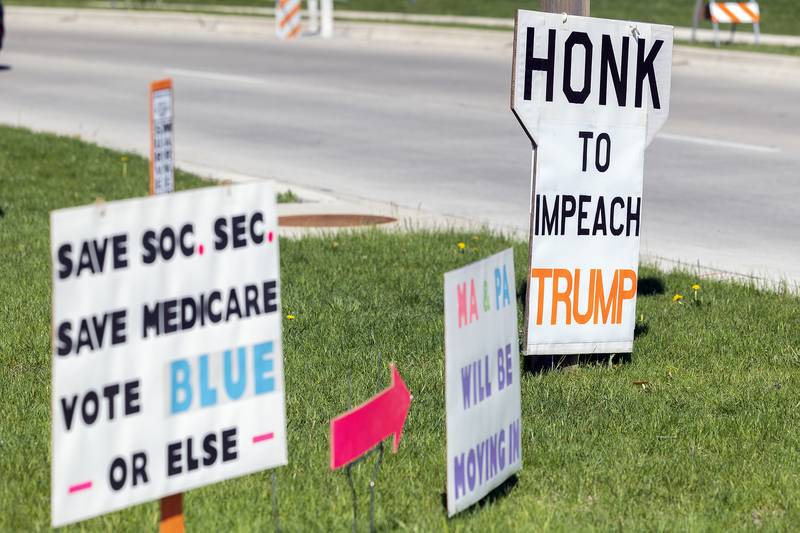 Signs along East Fourth Street in Sterling show off the increasing unhappiness with President Trump Saturday, May 3, 2025.