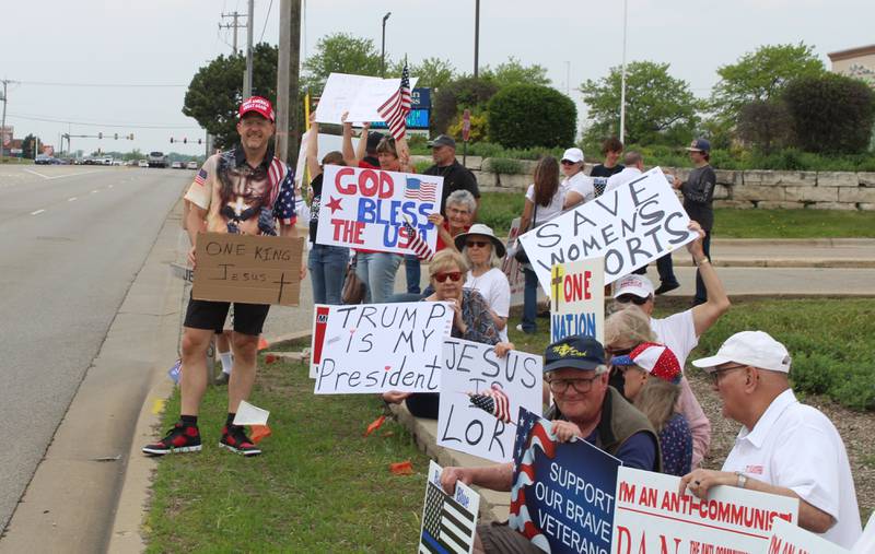 Attendees hold up signs during the "Rally of the Silent Majority" showing support for President Donald Trump and the National Day of Prayer on May 17, 2026, in McHenry.