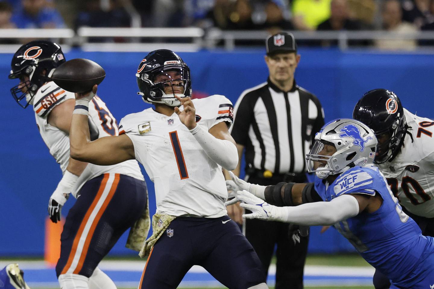 Chicago Bears quarterback Justin Fields is pressured during the second half against the Detroit Lions, Sunday, Nov. 19, 2023, in Detroit.