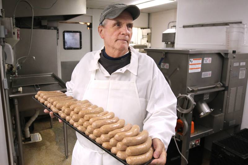 Thomas Inboden, U.S. Army veteran and owner of Inboden’s Gourmet Meat and Specialty Foods in DeKalb, carries out some sausages Tuesday Sept. 19, 2023, at his store. Inboden talked about how his service in the Army helped prepare him to become a successful business owner after taking over from his father Ocie O. Inboden.