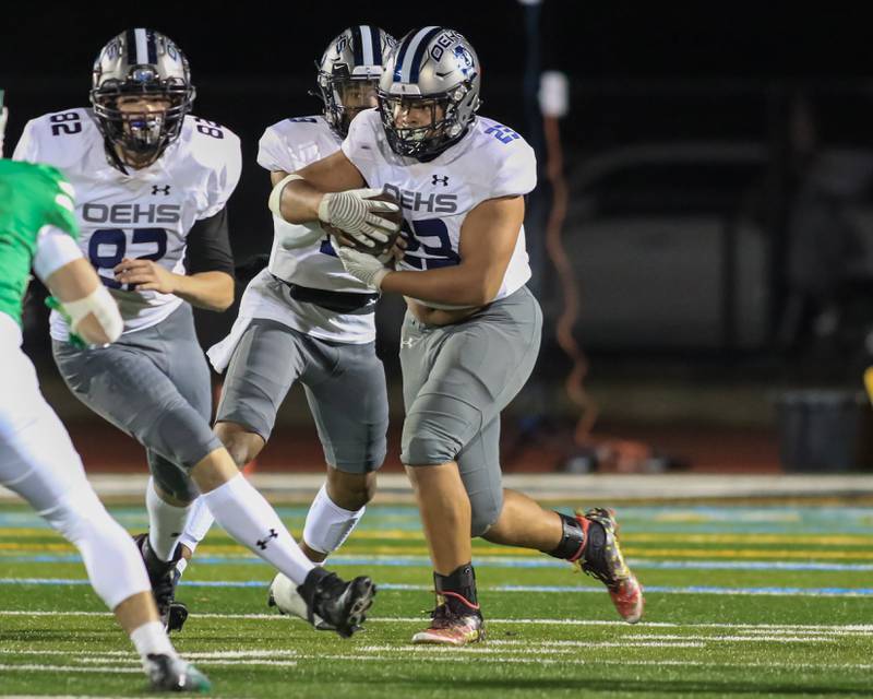 Oswego East's Oshobi Odior (23) takes the handoff from Oswego East's Robert Tyre Jones III (9) during Class 8A Playoff football game between Oswego East at York.  Oct 28, 2022.