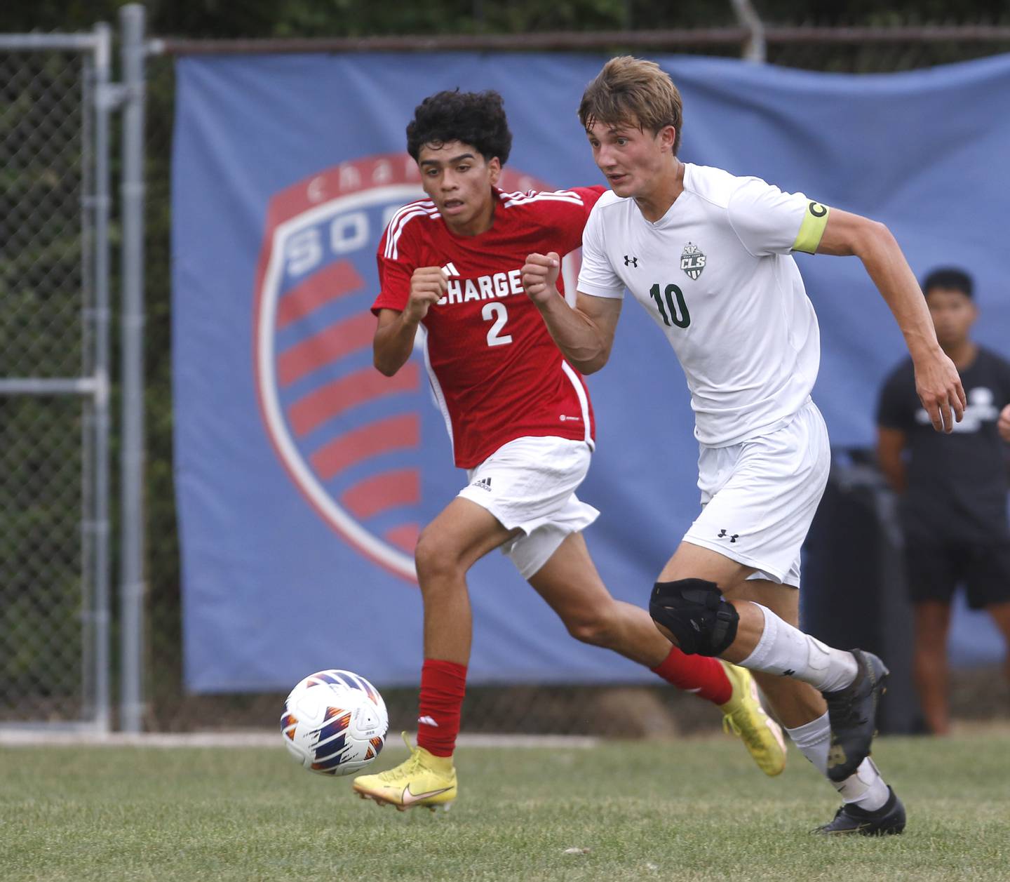 Crystal Lake South's Nolan Getzinger pushes the ball up the field against Dundee-Crown's Alex Beltran during a Fox Valley Conference soccer match Tuesday, Sept. 5, 2023, at Dundee-Crown High School in Carpentersville.