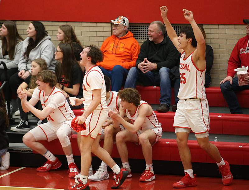 Members of the Ottawa boys basketball team celebrate after defeating L-P 56-45 in Kingman Gymnasium on Friday, Feb. 10, 2023 at Ottawa High School.