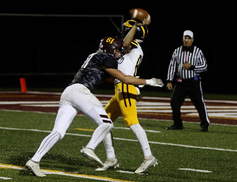 Richmond-Burton's Owen Wisniewski hits Harvard's Adam Cooke as he throws the ball during a Kishwaukee River Conference football game on Thursday, Oct.12, 2023, at Richmond-Burton High School.