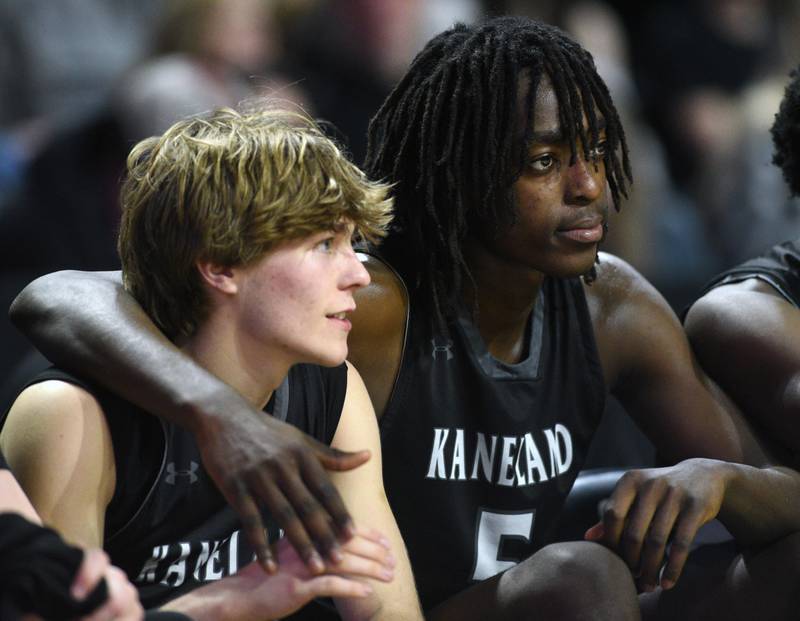 Kaneland's Luke Reinert, left, and Freddy Hassan sit together on the bench during the Class 3A boys supersectional at NOW Arena on Monday, March 10, 2025 in Hoffman Estates.
