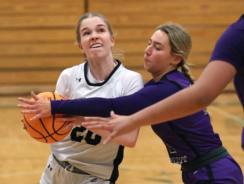 Kaneland's Samantha Kerry drives by Dixon’s Reese Dambman during their Class 3A sectional semifinal game Tuesday, Feb. 25, 2025, at Boylan Catholic High School in Rockford.