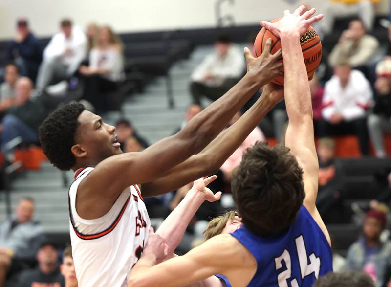 DeKalb’s Justin O’Neal grabs a rebound over Geneva’s Luke Matan Thursday Dec. 28, 2023, during their second round game in the 96th Chuck Dayton Classic boys basketball tournament at DeKalb High School.