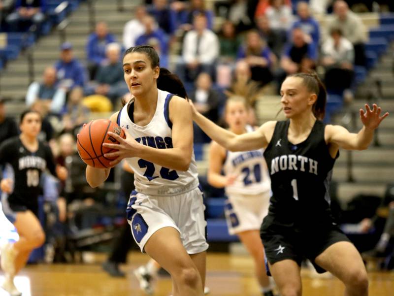 Geneva’s Leah Palmer passes the ball away from St. Charles North’s Laney Stark during a game at Geneva on Tuesday, Feb. 6, 2024.