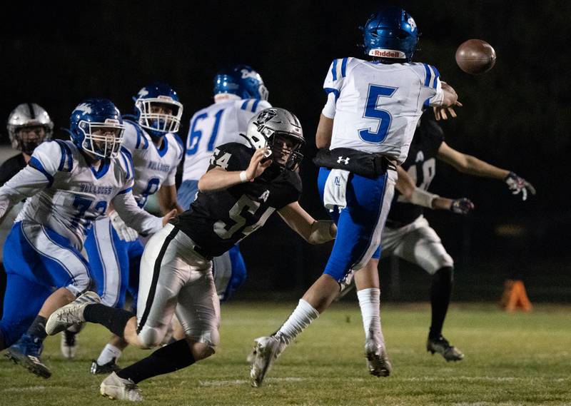 Kaneland’s Christian Morgan (54) pressures Riverside Brookfield's Diego Gutierrez (5) in the backfield during a 6A playoff football game at Kaneland High School in Maple Park on Friday, Oct 28, 2022.