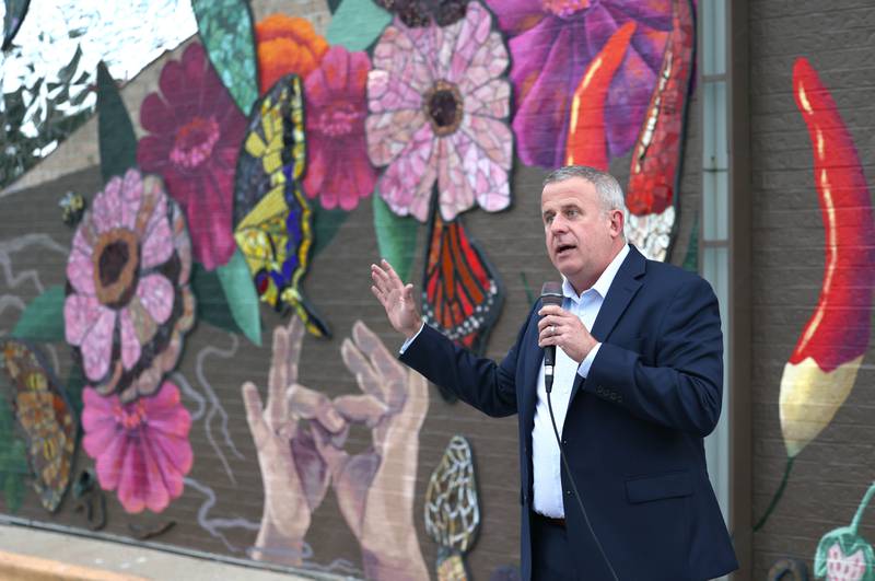 DeKalb Mayor Cohen Barnes makes remarks Thursday, Oct. 19, 2023, during the unveiling and ribbon cutting of the new City Hall mural created by artist Danielle Casali. The mural is on the on the south wall of City Hall and was completed with the help of many volunteers who wanted to be a part of the project.