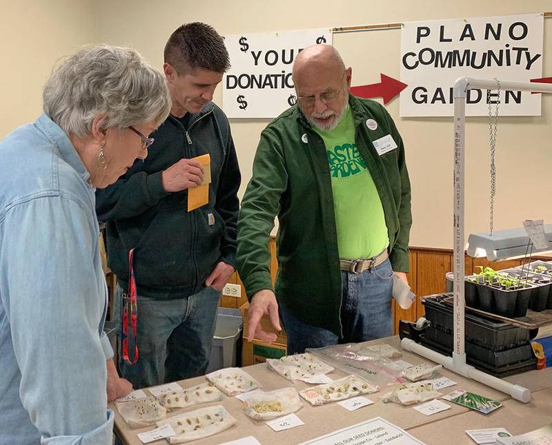 Master Gardener Steve Wolf of Sandwich (right) explains the seed germination test demonstrations at the 2020 seed swap.