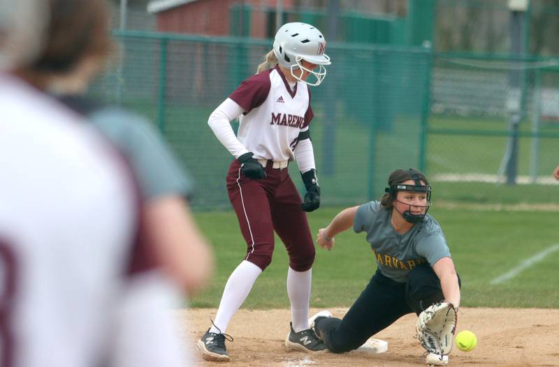 Marengo’s Kylee Jensen arrives safely at third base as  Harvard’s Britta Livdahl fields a throw in varsity softball at Marengo Thursday.