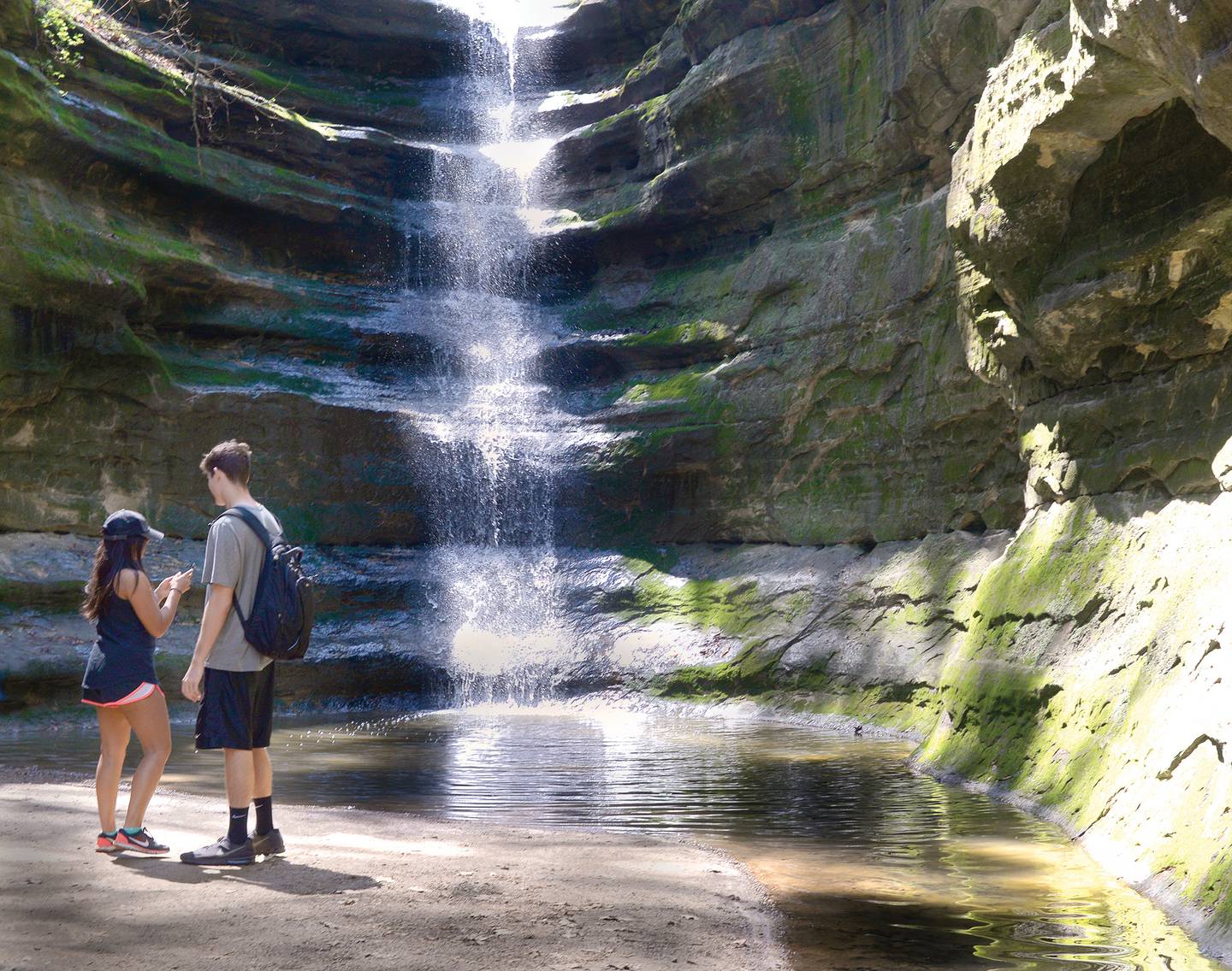 A couple prepares to photograph the waterfall at French Canyon in Starved Rock State Park.