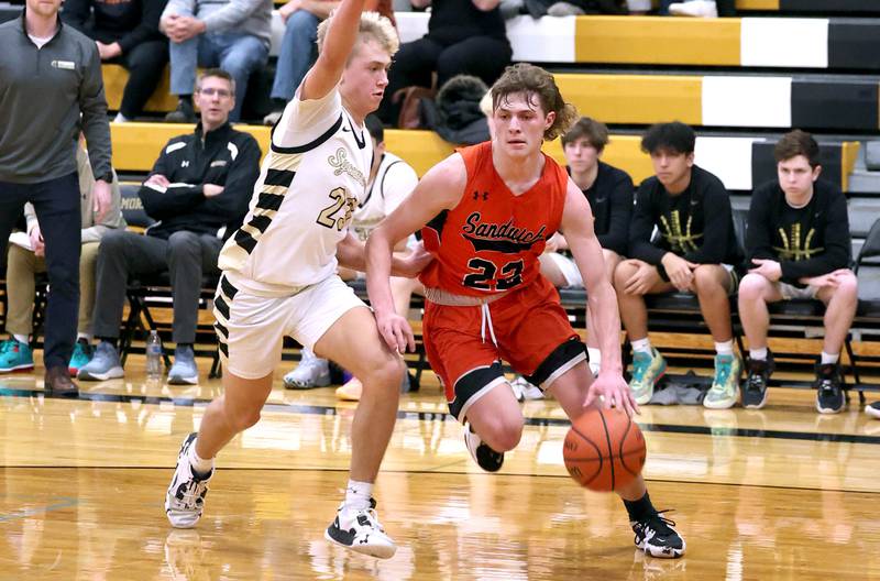 Sandwich's Austin Marks goes baseline against Sycamore's Carter York during their game Tuesday, Jan. 17, 2023, at Sycamore High School.