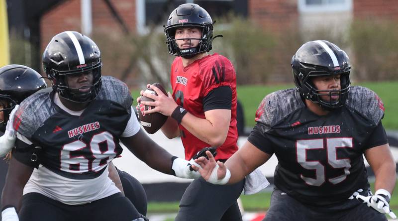 Northern Illinois University quarterback Brady Davidson gets good protection from offensive lineman Samir Senenat (left) and Ty Mead Tuesday, April 14, 2026, during spring practice in Huskie Stadium at NIU in DeKalb.
