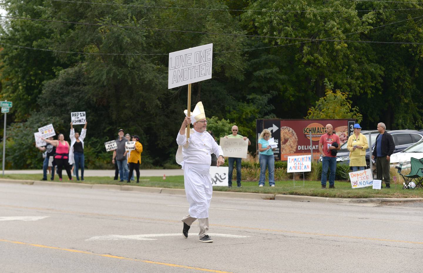 John O'Rourke of Downers Grove dresses as Pope Leo XIV to provide a symbol and sign of kindness while participating Saturday in the No Kings Day protest in Lisle. The rallies took place in both DuPage and Cook counties.