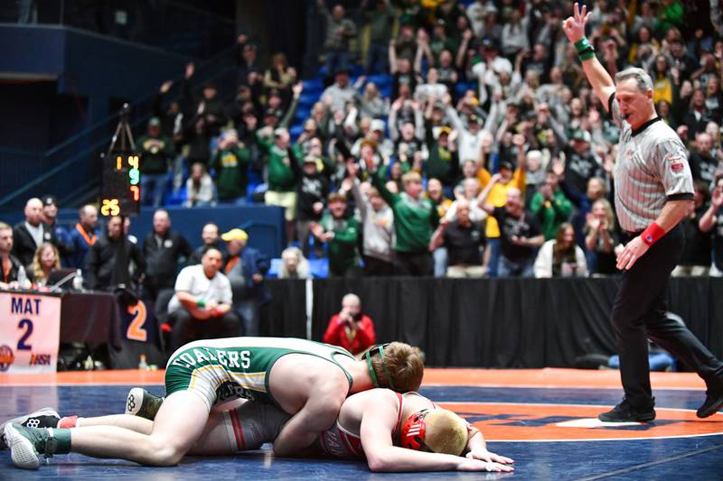 The fan section erupts as Coal City's Aidan Kenney tallies three more points against Cole Yarbrough of Vandalia during Kenney's 144-pound victory that secured the Coalers' IHSA Class 1A Dual Team State title in Bloomington on Saturday, March 1.
