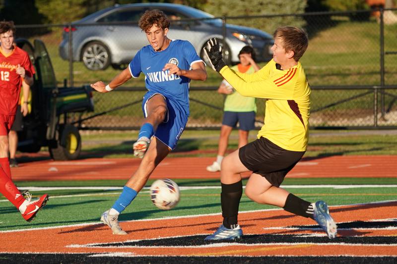 Geneva’s Alexander Graham (14) shoots the ball for a goal against Batavia’s Teagan Carlson (1) during a soccer match at St. Charles East High School on Thursday, Sep 26, 2024.