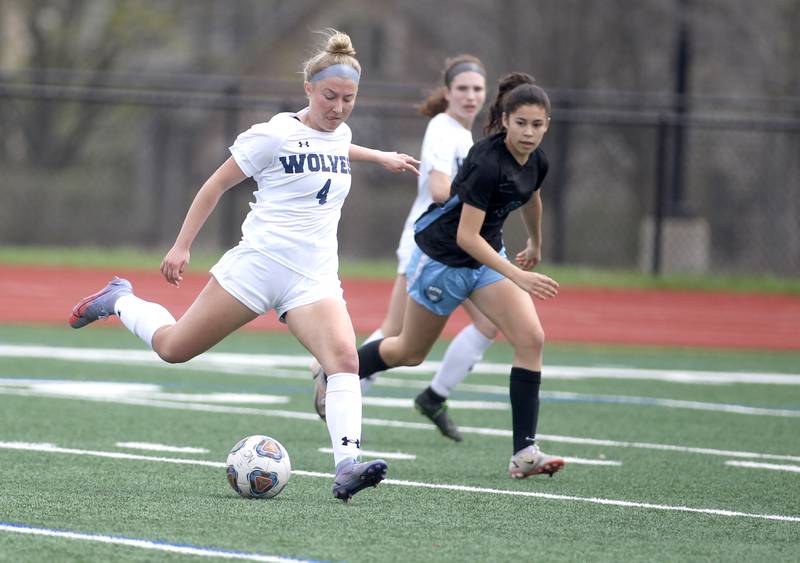 Oswego East’s Mikayla Lambert kicks the ball during a Naperville Invitational game against St. Charles North at Naperville Central on Saturday, April 23, 2022.