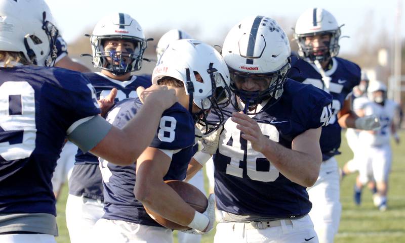 Cary-Grove’s Andrew Prio, center, is greeted by Logan Abrams, right, after a Prio touchdown against Geneva in IHSA Class 6A quarterfinal playoff football action at Cary Saturday.