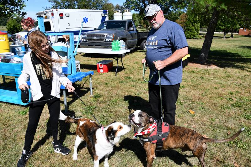 Sophia Judd with Cocoa and Bill Jacobsen with Mayday attend the dog walk event Saturday, Sept. 25, 2021, at Baker Lake in Peru for the Illinois Valley Animal Rescue.