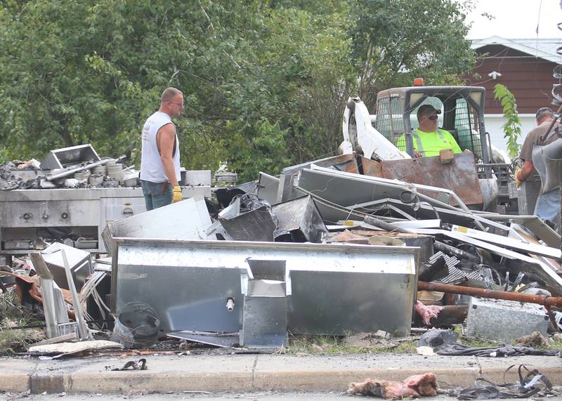 Workers sift through scrap metal at the Cindy's on 39 restaurant (formally Delaney's) on Tuesday, Aug. 29, 2023 in Oglesby. A fire destroyed the restaurant in April. Otterbach Demolition in Mendota are removing debris from the establishment