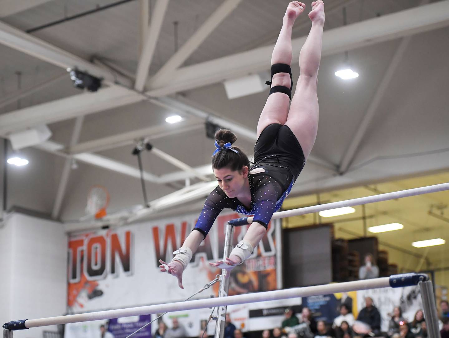 Wheaton Warrenville South’s Mia LaFratta on the uneven bars at the Wheaton Warrenville South gymnastics sectional meet on Thursday, Feb. 8, 2024.