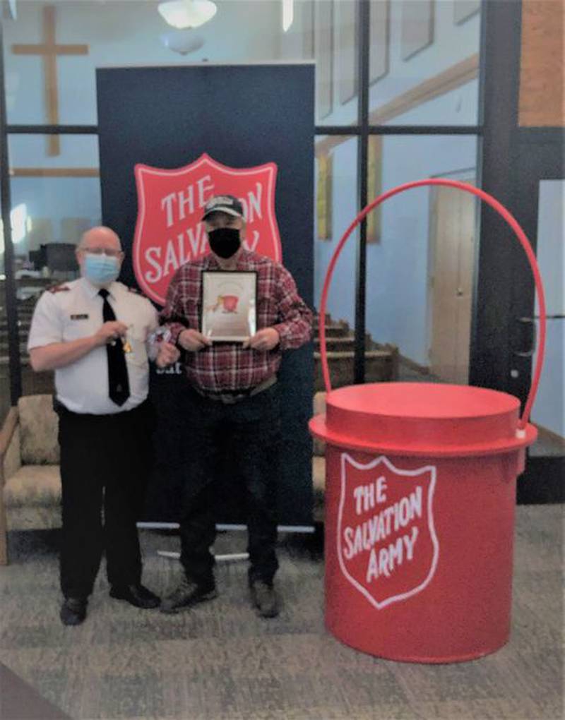 Salvation Army Tri-City Corps (St. Charles, Ill.) volunteer Jeff Bowgren, right, receives his "Bellringer of the Year" award from Tri-City Corps Lt. Scott Smith for collecting $11,444.80 in donations over 224 hours of ringing during past Christmas season.