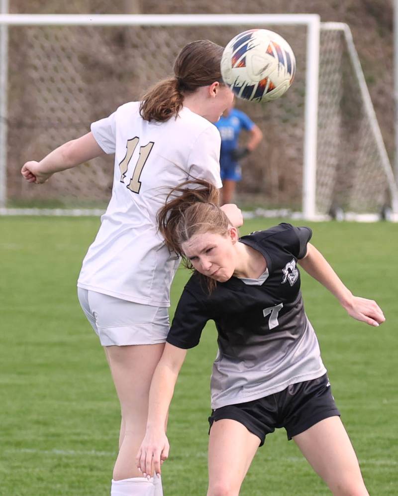Sycamore's Ellie Lawless heads the ball over Kaneland's Olivia Davis during their game Monday, April 13, 2026, at Kaneland High School.