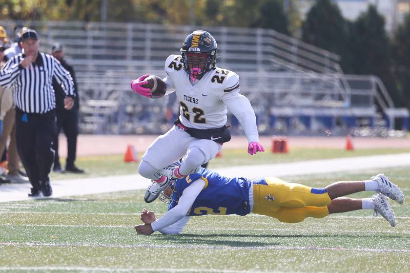 Joliet West’s LaDainian Tucker his brought down on long catch and run against Joliet Central on Saturday.