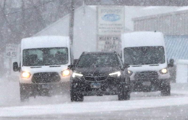 Traffic heads north through the blowing and falling snow Thursday, Dec. 22, 2022, on Peace Road in DeKalb. Snow, frigid temperatures and wind rolled into the area Thursday making travel a challenge.