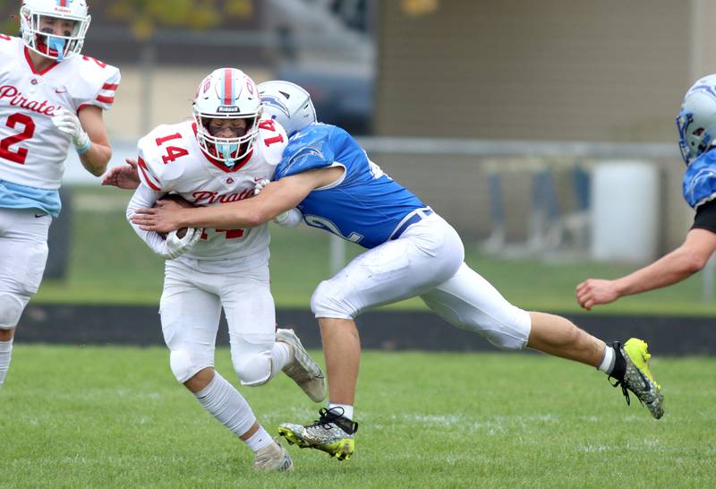 Woodstock’s Zachary Canaday, right, hits Ottawa’s Archer Cechowicz in varsity football at Larry Dale Field on the campus of Woodstock High School Saturday.