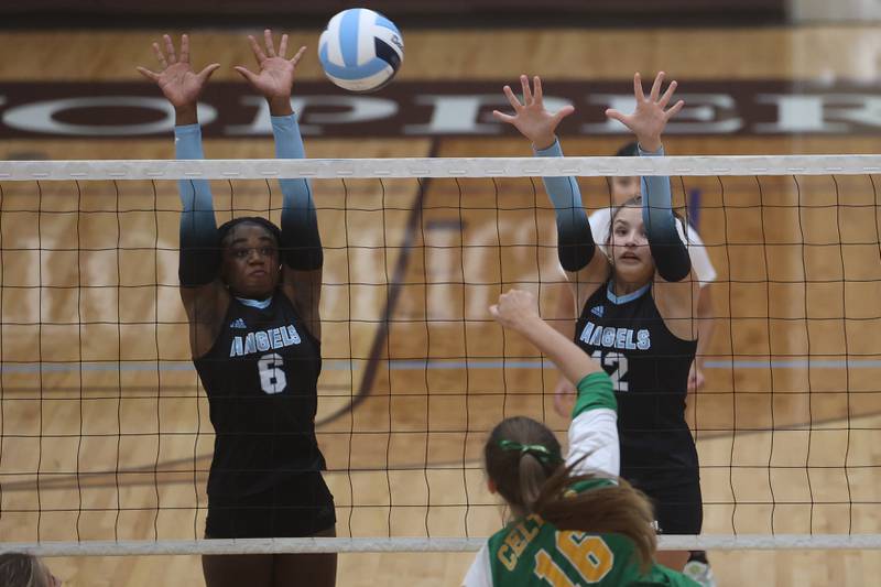 Joliet Catholic’s Heavenly Sarfo, left, and Ellie Blotnik go for the block against Providence on Thursday, Sept. 14, in Joliet.
