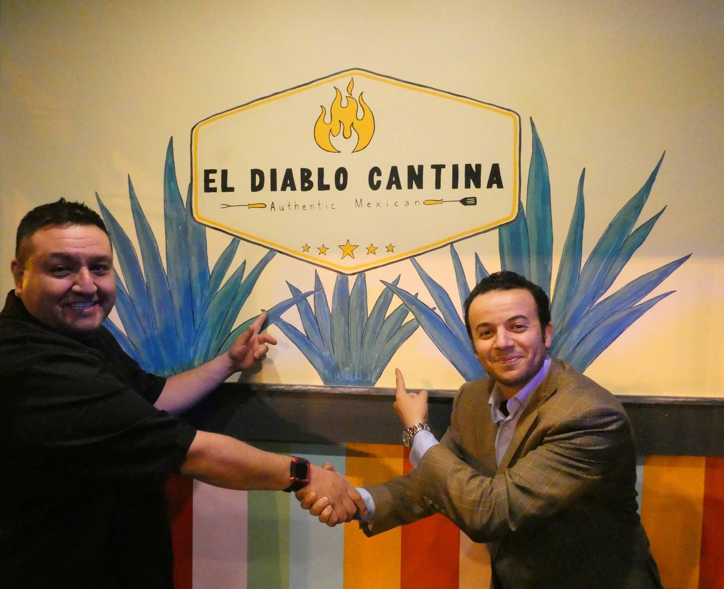Chef Roberto Barojas Alvarez, left, and owner Marwan Taib, right, pose in front of their new restaurant, El Diablo Cantina, on Saturday, March 5, 2022.