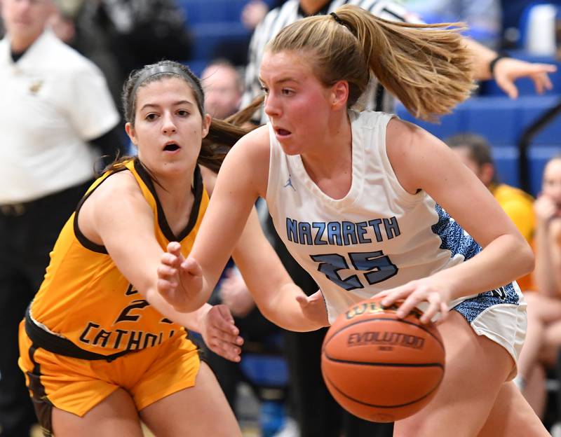 Nazareth's Amalia Dray (25) drives past Carmel's Anna Hartman during the ESCC conference tournament championship game on Feb. 4, 2023 at Nazareth Academy in LaGrange Park.