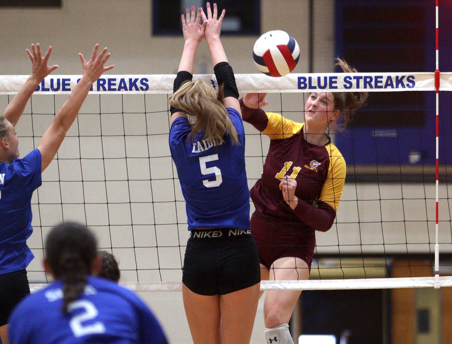 Richmond-Burton’s Maggie Uhwat sends the ball over the net in varsity volleyball at Woodstock Monday night.