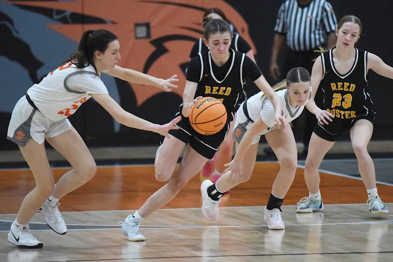 Reed-Custer's Alyssa Wollenzein, center, splits a pair of Beecher defenders during a game at Beecher Tuesday, Jan. 20, 2026.