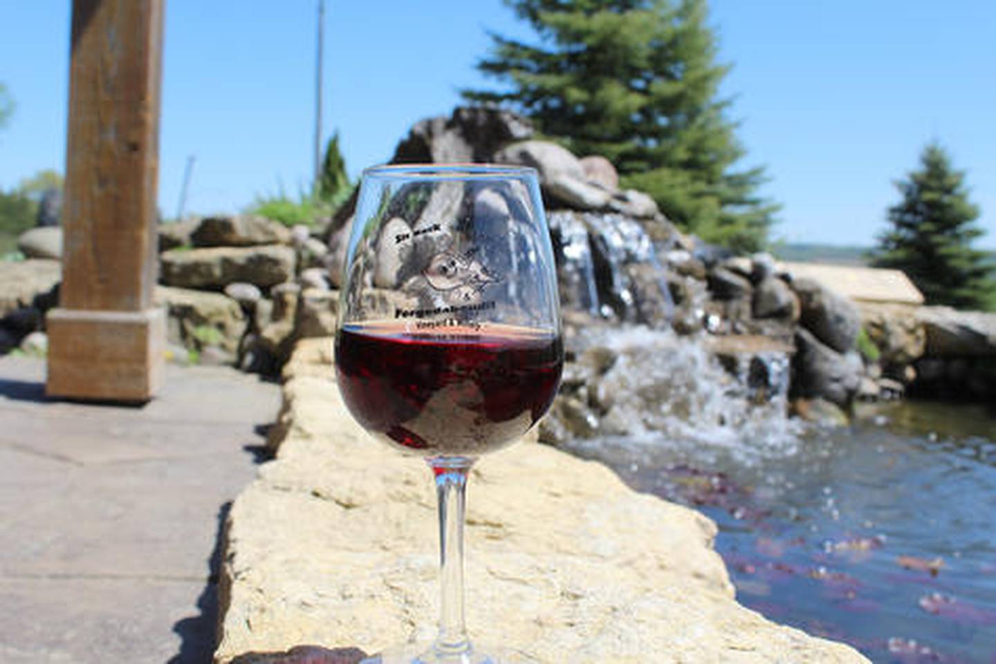 Enjoying a glass of wine is done in a peaceful, quiet setting at Fergedaboudit, complete with unique views of Driftless Area topography.