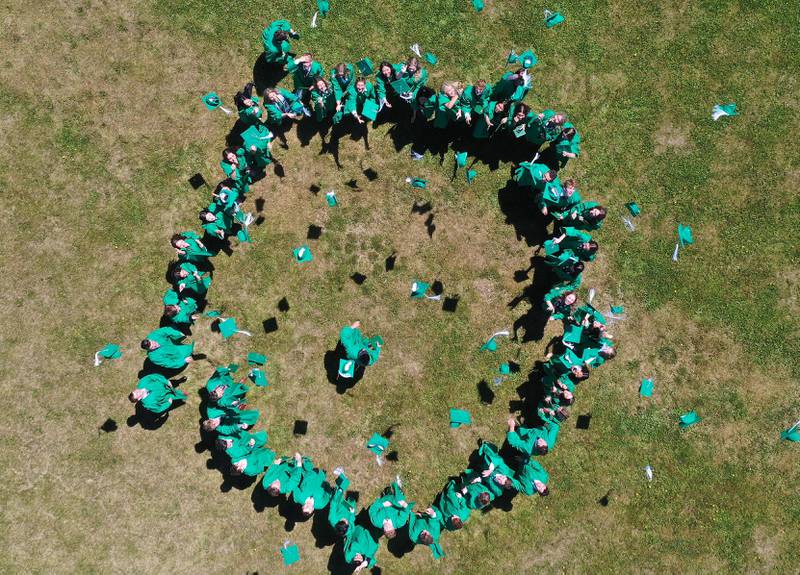 Members of the St. Bede Class of 2025 throw caps in the air after 133rd annual commencement ceremony on Sunday, May 18, 2025 at St. Bede Academy.