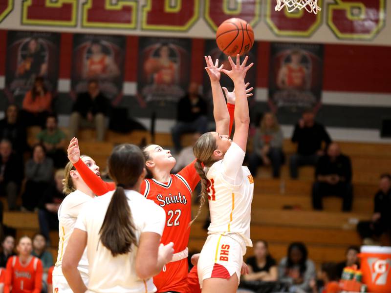 Batavia’s Kylee Gehrt (right) goes for a rebound against St. Charles East’s Sydney Axelsen during a game at Batavia on Thursday, Feb. 1, 2024.