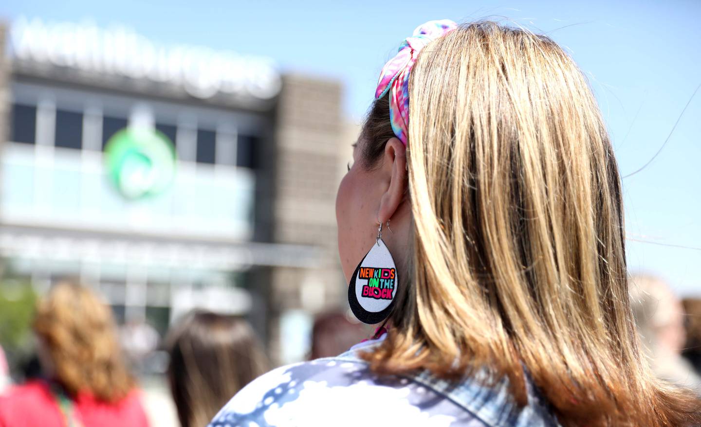 New Kids on the Block fan Heather Parrett of Fort Worth, Texas waits outside Wahlburgers in St. Charles for a "WahlCon" pre-party on Thursday, May 25, 2023.
