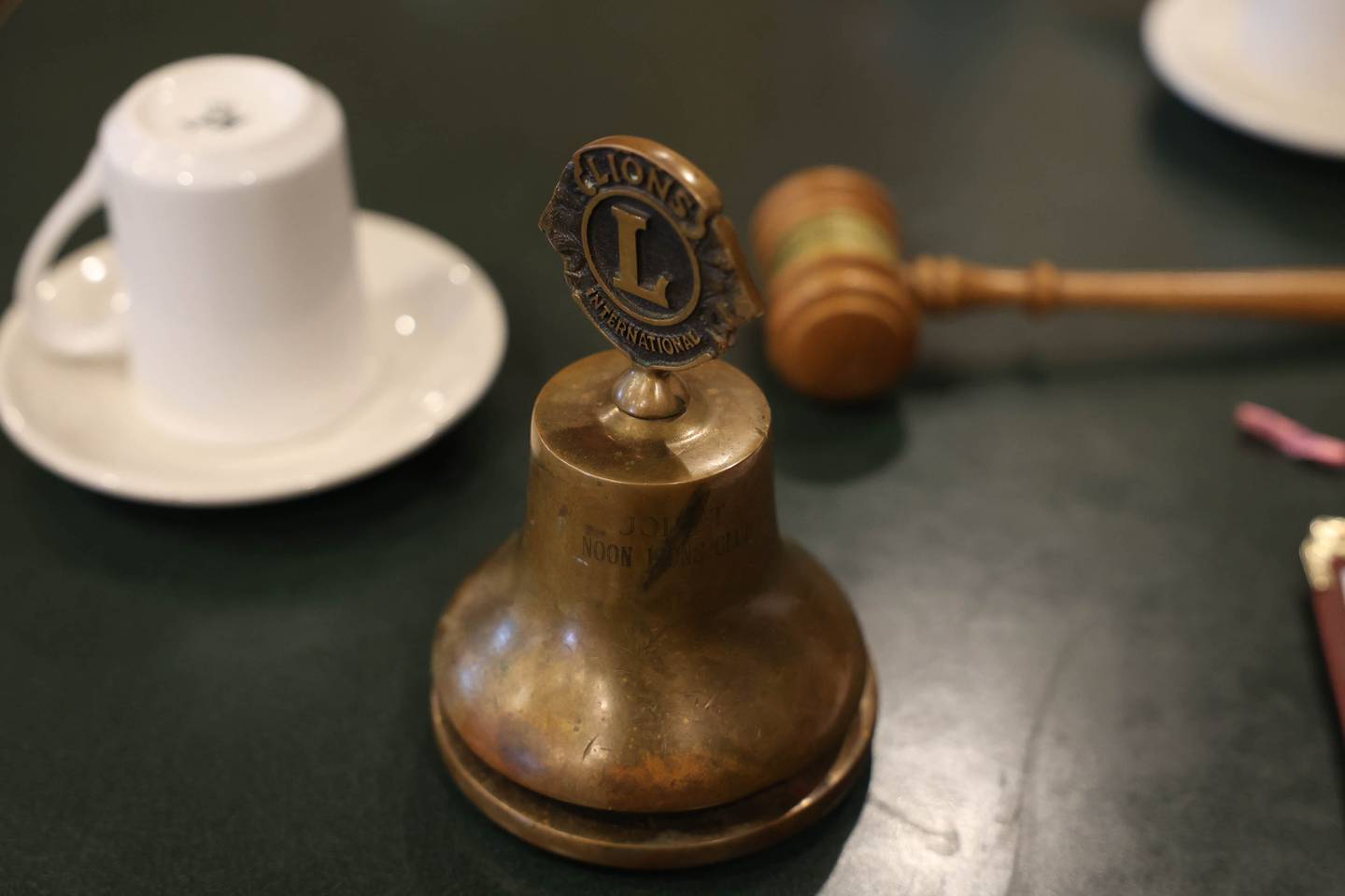 A gavel and custom bell sits on the table at the Joliet Noon Lions Club meeting at the Silver Spoon restaurant on Thursday, Sept. 22, 2022, in Joliet. The Joliet Noon Lions Club, a community outreach organization, celebrated its 101st anniversary this year.