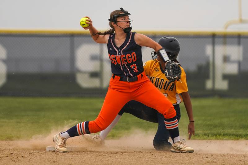 Oswego’s Kennedy Gengler (9) throws to first to turn a double play against Neuqua Valley during a Class 4A Oswego East Regional Final softball game at Oswego East High School on Friday, May 30, 2025.
