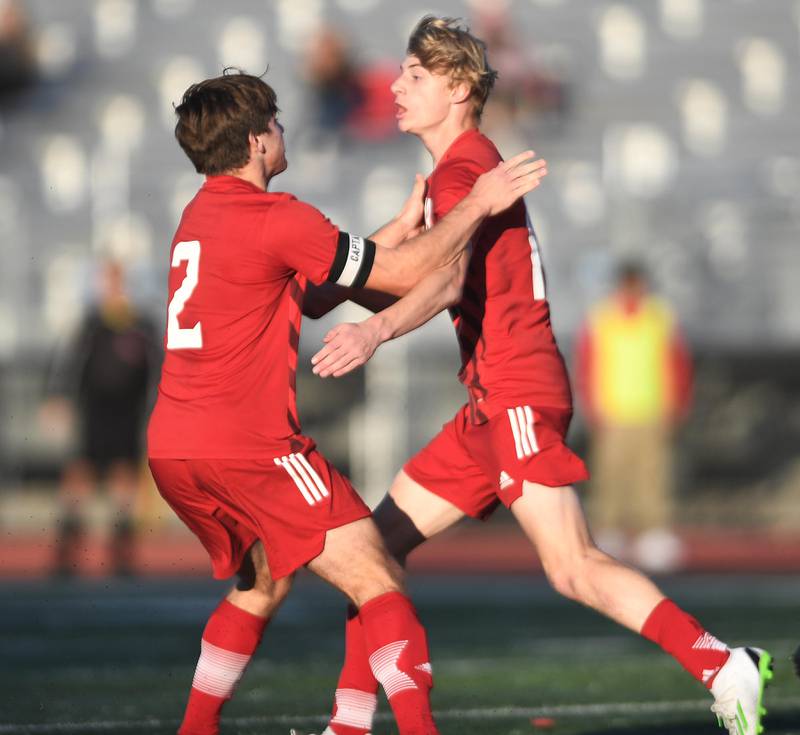 Naperville Central’s Michael Cavalleri, right, is met by teammate Patrick Bohan after scoring against Hinsdale Central in the Class 3A East Aurora supersectional boys soccer game on Tuesday, November 1, 2022.
