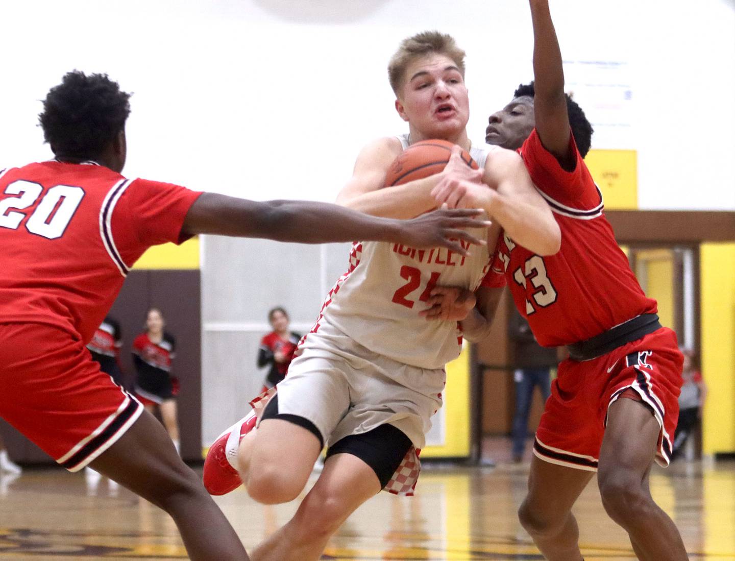 Huntley’s Aiden Wieczorek, center, muscles his way under the hoop against Rockford East’s Jemere Jefferson, right, during IHSA Class 4A Regional Championship game action Friday night at Jacobs High School in Algonquin.