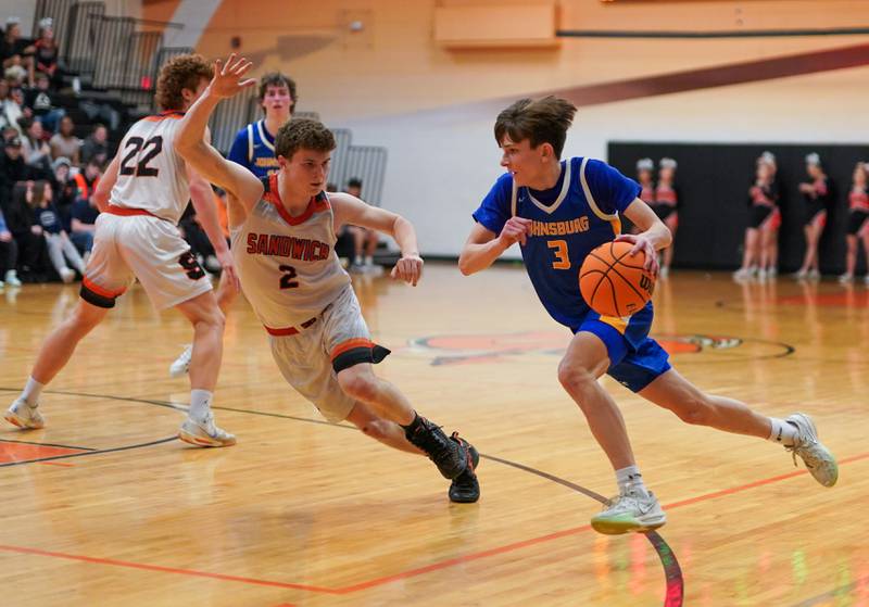 Johnsburg's Trey Toussaint (3) drives to the basket against Sandwich's Griffin Somlock (2) during a basketball game at Sandwich High School on Friday, January 31, 2025.