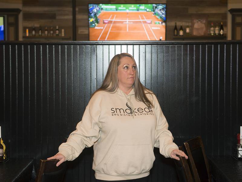 Saleena Surratt listens as Frerichs talks about the program to some of the staff at Smoked on Third.